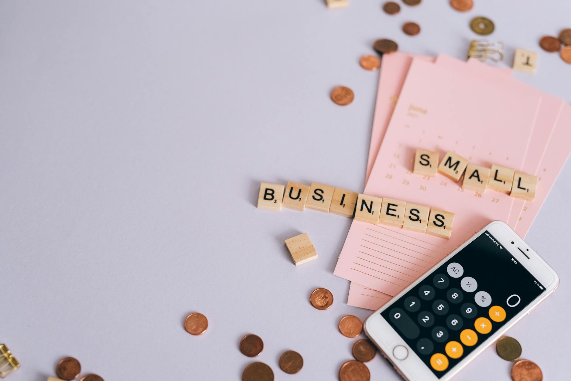 Small business owner comparing ad platform costs with calculator and coins on desk, illustrating Google Ads vs Meta Ads budge