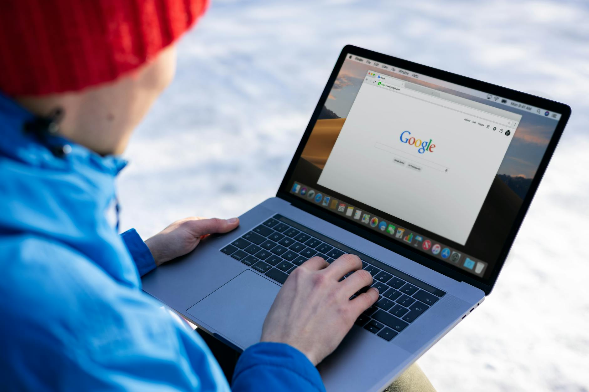 Professional using laptop to automate Google Business Profile review management system outdoors