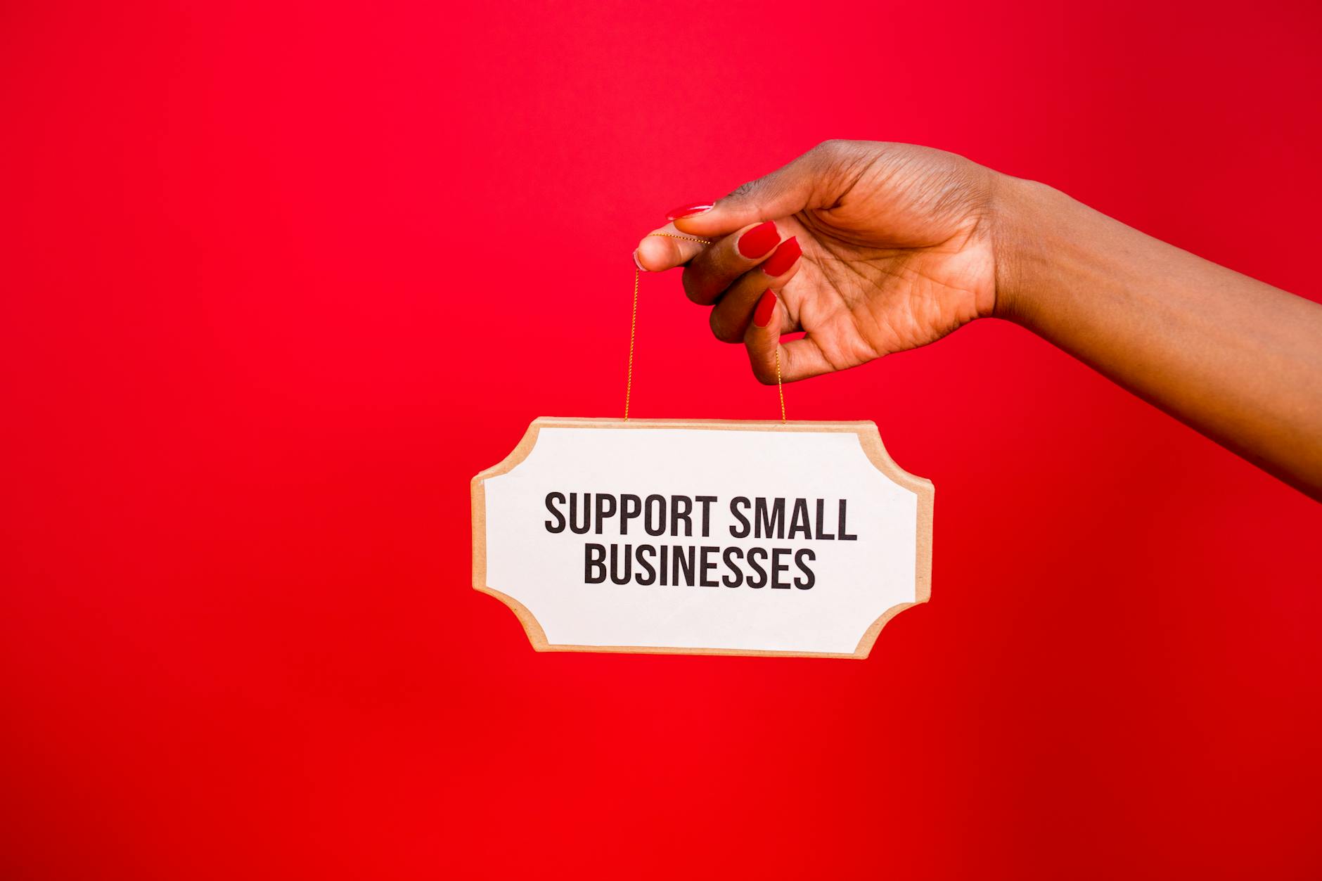 Small business owner holding support sign demonstrating local SEO strategy for Australian companies