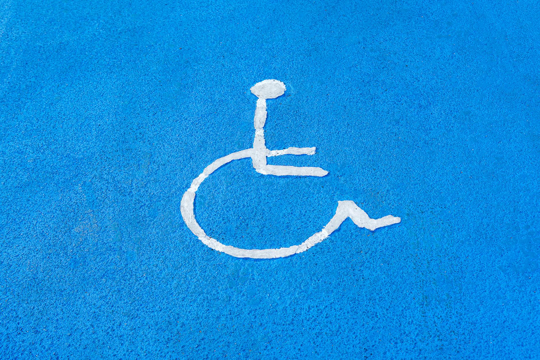 Accessible NDIS provider website design requirements displayed through inclusive signage symbolism