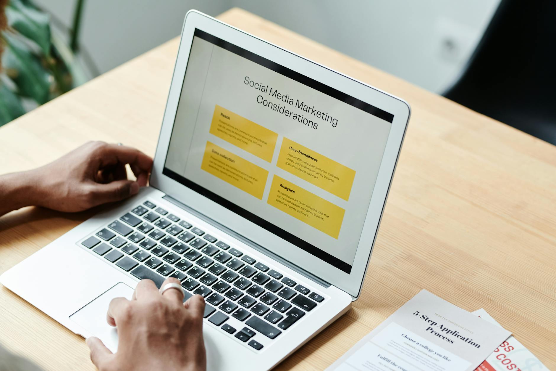 Small business owner reviewing paid media campaign performance on laptop for Google Ads and Meta Ads strategy