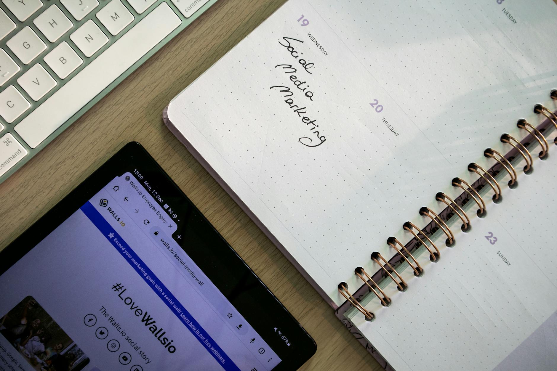 Paid media planning workspace with notebook, tablet and keyboard for Australian small business advertising strategy