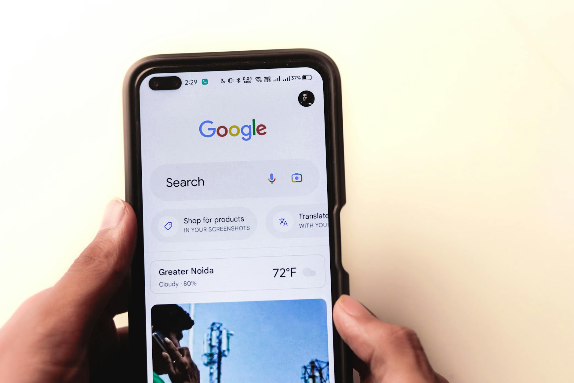 Hand holding smartphone displaying Google search results for Australian small business paid media strategy