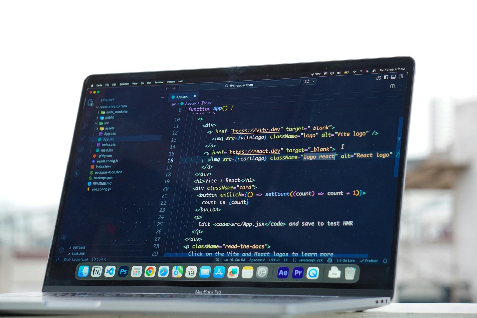 Developer coding on laptop comparing React and WordPress frameworks for Australian business website development