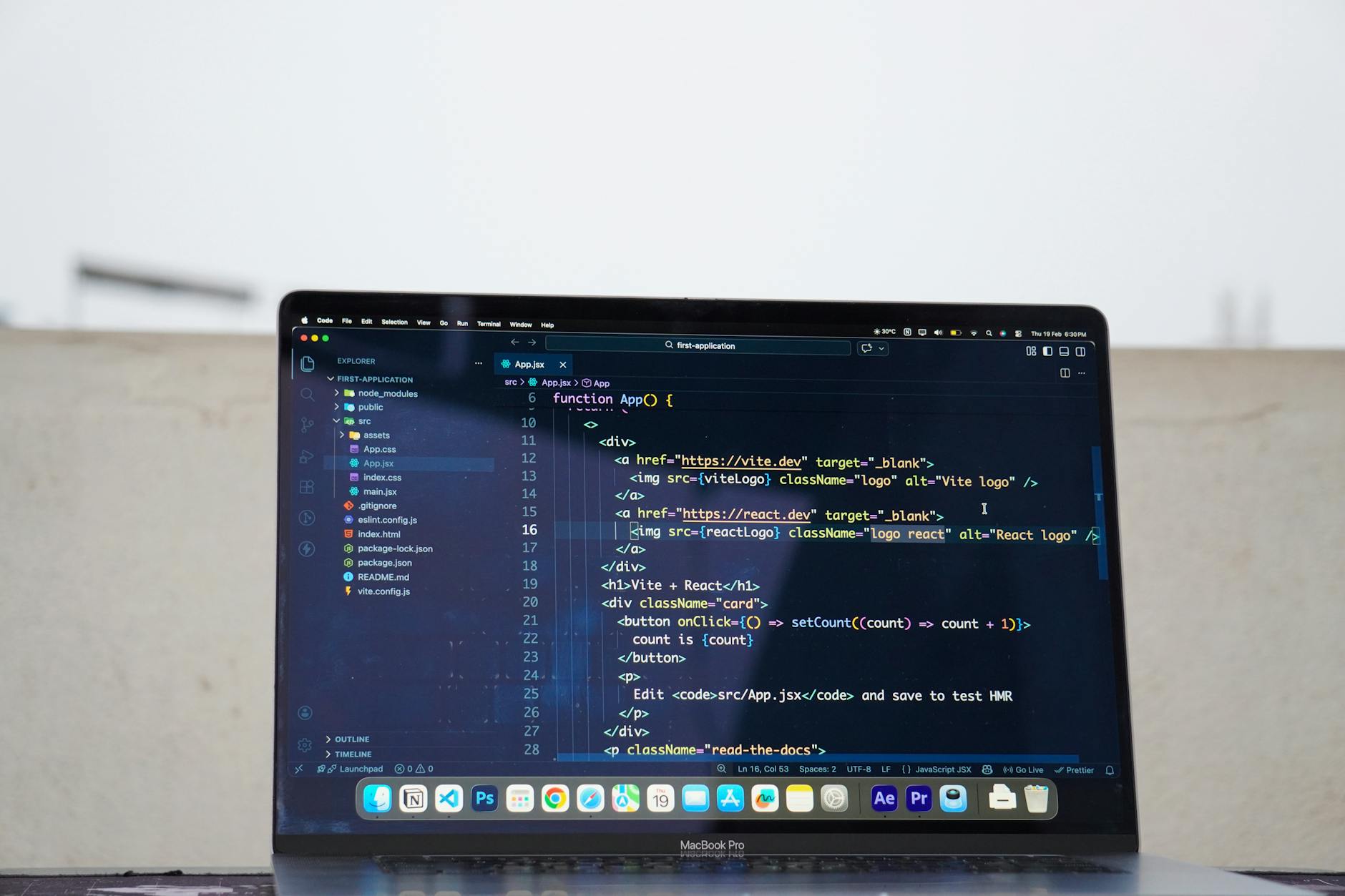 Developer writing React code on laptop outdoors, comparing frameworks for Australian small business websites in 2026